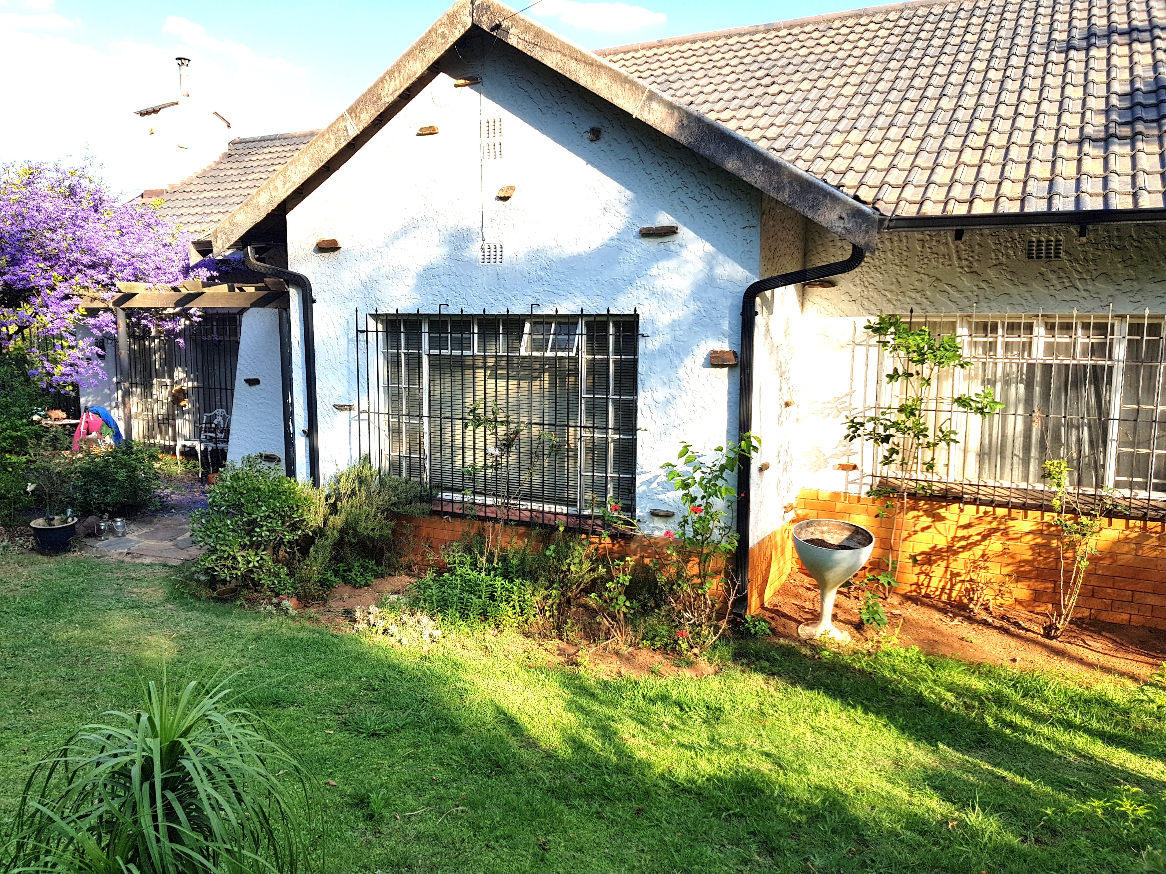 A golden oldie house, pitch roof, sky blue paint, spanish burglar bars. Sold by one of my agents