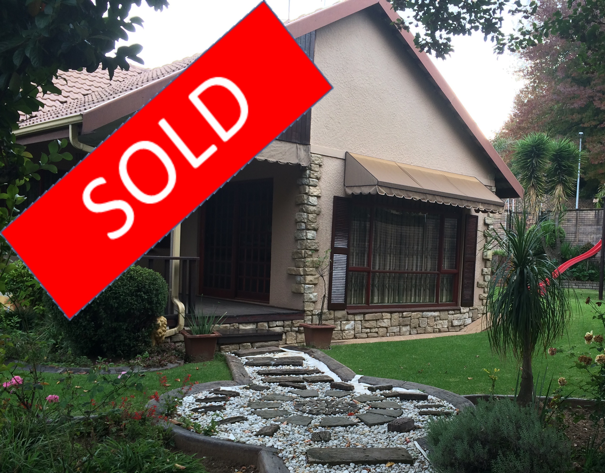 Picture of house I sold with a Sold banner on it